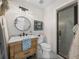 Elegant bathroom with a wooden vanity, black fixtures, and tiled shower at 3412 Ace Ln, Dover, FL 33527