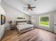 Bedroom with wood-look floors, two side tables, and two windows at 3412 Ace Ln, Dover, FL 33527