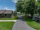 Long driveway leading to a charming home with mature trees and well-manicured landscaping, creating a welcoming entrance at 3412 Ace Ln, Dover, FL 33527