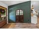 Inviting foyer with wood-look flooring and an attractive accent wall with double doors at 3412 Ace Ln, Dover, FL 33527