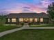 Charming single-story home with a welcoming front porch, lush landscaping and a brick walkway at 3412 Ace Ln, Dover, FL 33527