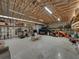 Spacious garage interior with high ceilings and exposed beams, offering ample storage and workspace at 3412 Ace Ln, Dover, FL 33527