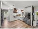 Beautiful white kitchen featuring stainless steel appliances and a farmhouse sink at 3412 Ace Ln, Dover, FL 33527