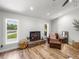 Inviting living room featuring a cozy fireplace and stylish, comfortable leather seating at 3412 Ace Ln, Dover, FL 33527