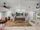 Spacious living room with hardwood floors, high ceilings, and large TV at 3412 Ace Ln, Dover, FL 33527