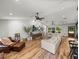 Spacious living area with abundant natural light, ceiling fans, and wood-look flooring at 3412 Ace Ln, Dover, FL 33527