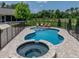 Private in-ground pool and spa surrounded by a brick patio, with backyard views at 3412 Ace Ln, Dover, FL 33527