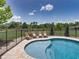 Inviting pool area with lounge chairs, surrounded by lush greenery and fencing for privacy, ideal for relaxation at 3412 Ace Ln, Dover, FL 33527