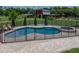 Fenced in-ground pool and spa adjacent to red barn at 3412 Ace Ln, Dover, FL 33527