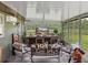 Bright sunroom with pastoral views, equipped with air conditioning and comfortable seating for relaxing and enjoying the scenery at 3412 Ace Ln, Dover, FL 33527