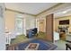 Bedroom with a murphy bed, desk, and a doorway leading to a living area at 36750 Us 19 N # 09208, Palm Harbor, FL 34684