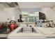 Kitchen counter with essentials appliances overlooking living space and outside view at 36750 Us 19 N # 09208, Palm Harbor, FL 34684