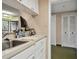 Efficient kitchen space featuring neutral countertops, cabinets, and a pass-through to living area at 36750 Us 19 N # 09208, Palm Harbor, FL 34684
