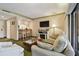 Inviting living room featuring a sofa, flatscreen television, and bar seating area at 36750 Us 19 N # 09208, Palm Harbor, FL 34684