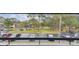 Parking lot view from balcony showing lush landscaping and assigned parking at 36750 Us 19 N # 09208, Palm Harbor, FL 34684