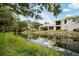 Backyard view of home featuring a waterway with lush green landscaping at 4130 Dolphin Dr, Tampa, FL 33617