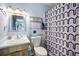 Bathroom featuring a vanity sink, toilet, and shower/tub with a stylish shower curtain at 4130 Dolphin Dr, Tampa, FL 33617