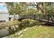 A bridge crosses a small creek with lush green landscaping and mature trees at 4130 Dolphin Dr, Tampa, FL 33617