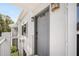 A close-up of the front door, unit 4130, with an overhead awning, secure lock, and decorative wall lamps at 4130 Dolphin Dr, Tampa, FL 33617