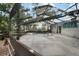 Enclosed pool area with a hot tub and surrounding views of the lake and trees at 4130 Dolphin Dr, Tampa, FL 33617