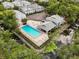 Aerial view of a community pool, patio, and seating area with a waterway view at 4130 Dolphin Dr, Tampa, FL 33617