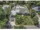 Aerial view of a well-maintained single-Gathering home with a green roof, inviting pool, and mature landscaping at 4206 W Palmira Ave, Tampa, FL 33629