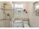 Bathroom featuring a glass shower, granite countertop, and decorative fish accents at 4206 W Palmira Ave, Tampa, FL 33629