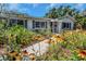 Well-maintained home featuring a walkway lined with vibrant flowers and lush greenery at 4206 W Palmira Ave, Tampa, FL 33629