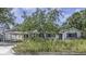 Charming single story home featuring a carport, mature landscaping, and a welcoming facade at 4206 W Palmira Ave, Tampa, FL 33629