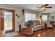 Inviting living room featuring hardwood floors, cozy furniture, and ample natural light at 4206 W Palmira Ave, Tampa, FL 33629