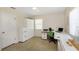 Office space with door, window, white desk, and neutral color scheme at 4206 W Palmira Ave, Tampa, FL 33629