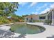Backyard featuring a kidney-shaped pool, patio furniture, a lush green lawn, and space for outdoor gatherings at 4206 W Palmira Ave, Tampa, FL 33629
