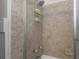Shower showcasing neutral-toned tiles and glass doors, and offering a clean, modern aesthetic at 4206 W Palmira Ave, Tampa, FL 33629