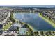 Scenic aerial view of a community, a large lake, a community pool, and tennis courts at 4547 Gardner St, Bradenton, FL 34210