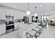 Modern open-concept kitchen with stainless steel appliances and an island with counter seating at 4547 Gardner St, Bradenton, FL 34210