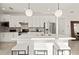 Modern kitchen featuring white cabinetry, stainless steel appliances, and stylish pendant lighting at 4547 Gardner St, Bradenton, FL 34210