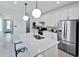 Modern kitchen with an island, white cabinetry, and stainless steel appliances at 4547 Gardner St, Bradenton, FL 34210