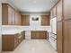 Modern kitchen with wood cabinets, white countertops, stainless steel appliances, and a wine refrigerator at 4616 W Estrella St, Tampa, FL 33629
