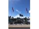 Community entrance with American and Canadian flags, water feature, and lush plants at 4851 W Gandy Blvd # B2L10, Tampa, FL 33611