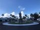 Community roundabout with a statue and well-manicured landscaping at 4851 W Gandy Blvd # B2L10, Tampa, FL 33611