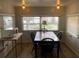 Bright dining area with a wooden table, four chairs, and ample natural light from the windows at 4851 W Gandy Blvd # B2L10, Tampa, FL 33611