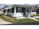 Cozy home with white siding, manicured lawn, and an American flag at 4851 W Gandy Blvd # B2L10, Tampa, FL 33611