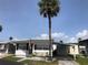 Charming single-story home featuring a carport and a lush green lawn at 4851 W Gandy Blvd # B2L10, Tampa, FL 33611