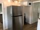 Kitchen area featuring stainless steel refrigerator and white cabinetry, ready for meal preparation at 4851 W Gandy Blvd # B2L10, Tampa, FL 33611