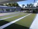 Beautiful shuffleboard courts surrounded by landscaping, club house, and seating at 4851 W Gandy Blvd # B2L10, Tampa, FL 33611