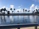 A serene water view with swaying palm trees, creating a tranquil atmosphere at 4851 W Gandy Blvd # B2L10, Tampa, FL 33611