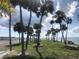 Picturesque waterfront walkway lined with palm trees and benches, perfect for relaxing at 4851 W Gandy Blvd # B2L10, Tampa, FL 33611