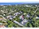 Overhead view of condo community near the bay with a pond, fountain, pool, and mature landscaping at 500 New York Ave # 22, Dunedin, FL 34698