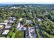 Comprehensive aerial shot showing the property's location within a vibrant, green neighborhood near the water at 500 New York Ave # 22, Dunedin, FL 34698