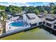 Elevated shot revealing a community pool, serene pond, and lush landscaping for a tranquil atmosphere at 500 New York Ave # 22, Dunedin, FL 34698